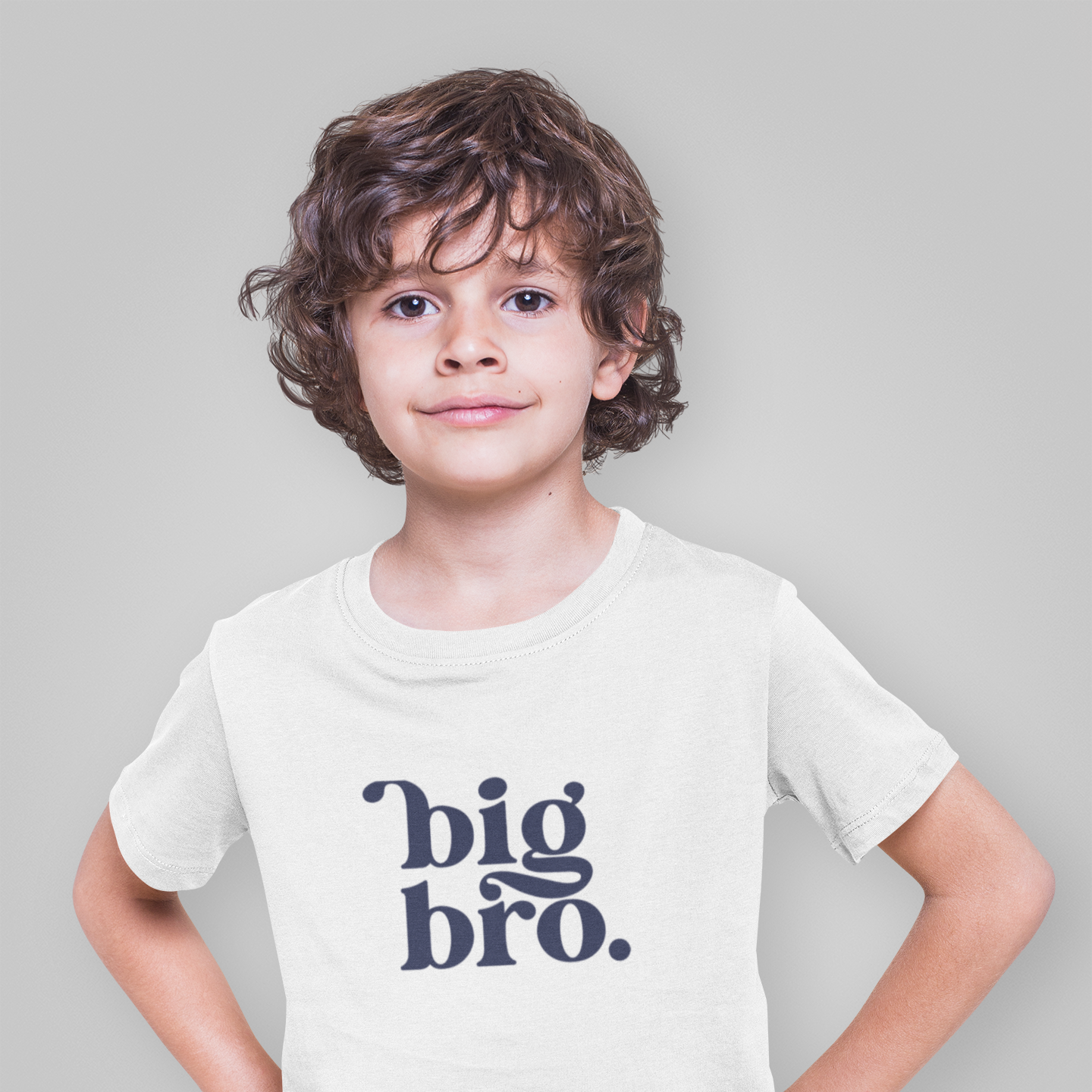 Child wearing a white t-shirt with 'big bro.' text on a plain background